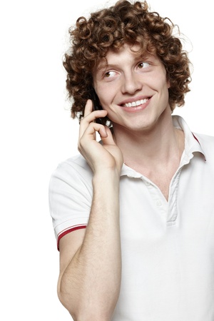 Happy man answering the phone against a white backgroundの写真素材