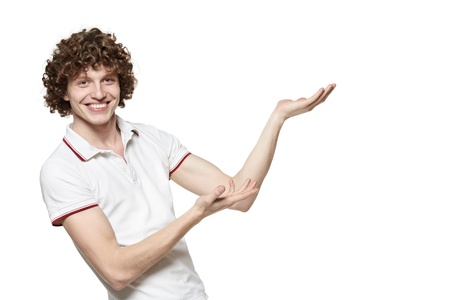 Portrait of young smiling man showing the blank copy space over white backgroundの写真素材