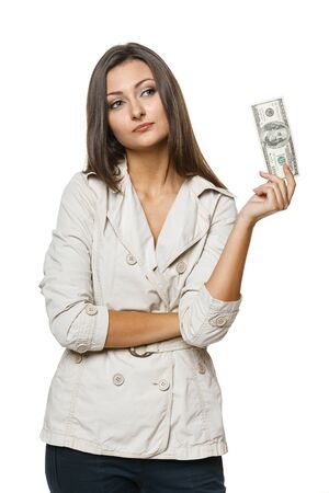 Pretty woman holding dollar money and contemplating, over white backgroundの写真素材