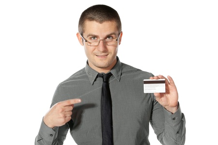 Young business man pointing to the credit card, isolated on white backgroundの写真素材