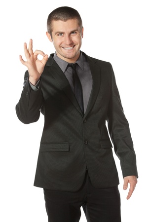 Happy businessman showing OK sign, isolated on white backgroundの写真素材