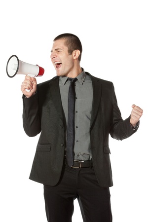 Portrait of a young business man yelling into a megaphone の写真素材