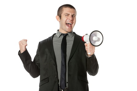 Portrait of a young business man yelling into a megaphone の写真素材