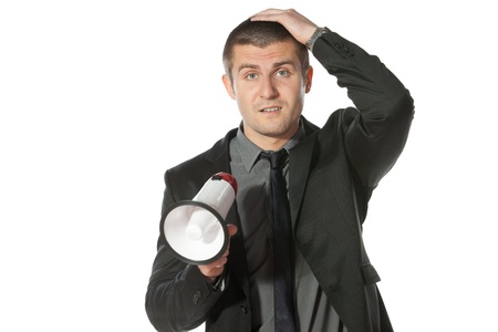 Portrait of a young business man holding megaphone の写真素材