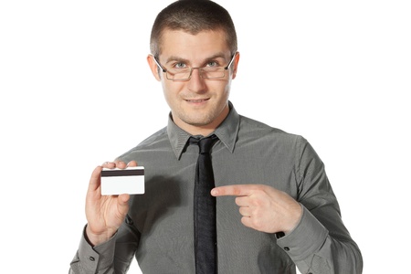 Young business man pointing to the credit card, isolated on white backgroundの写真素材