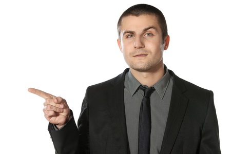 Close up of young business man pointing at copy space over white backgroundの写真素材