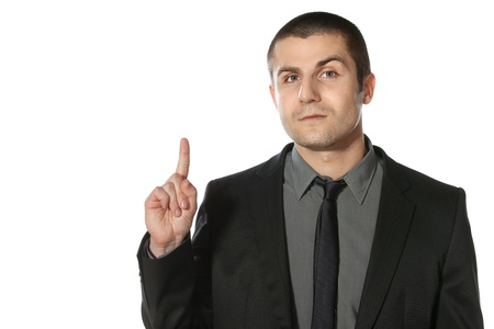 Close up of young business man pointing up at copy space over white backgroundの写真素材