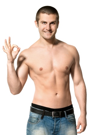 Handsome male model topless showing OK sign over white backgroundの写真素材