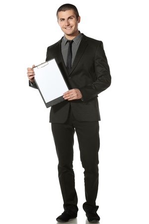 Full length of businessman holding blank board, isolated on white backgroundの写真素材