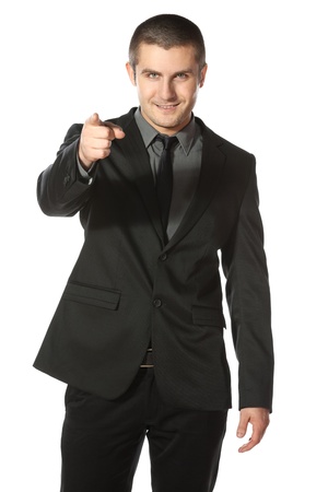 Portrait of a smiling young business man pointing at you over white backgroundの写真素材