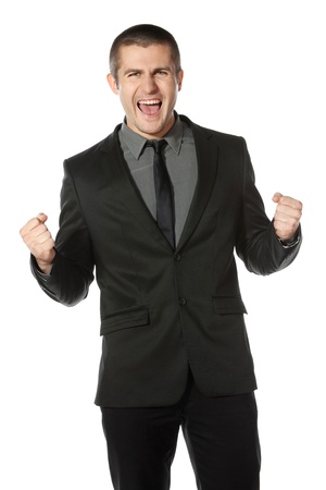 Happy young business man celebrating success over white backgroundの写真素材