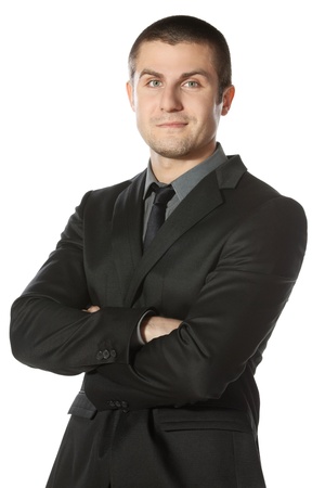 Portrait of young businessman with hands folded isolated on white backgroundの写真素材