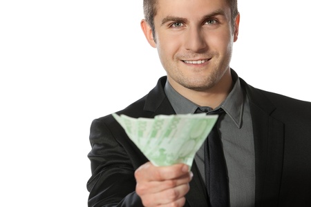 Young business man offering pack of Euro money over white backgroundの写真素材