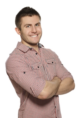 Portrait of handsome young man smiling over white background with hands foldedの写真素材