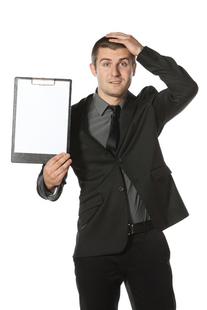 Young anxious businessman holding his head with hands. Worried businessman holding blank board, isolated on white backgroundの写真素材