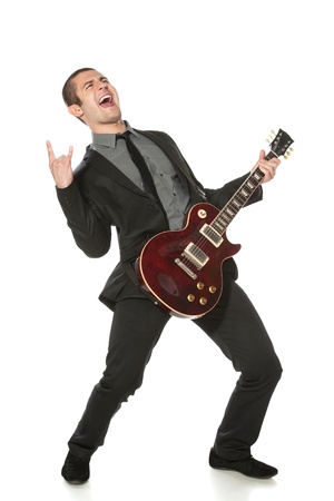 Full length of young man in a suit with guitar over white backgroundの写真素材