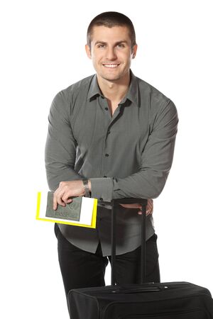 Guy leaning on his baggage ready for departure, isolated on white backgroundの写真素材