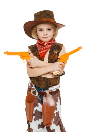 Little girl with wearing cowboy costume holding guns, over white backgrounfの写真素材