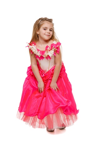 Fetching 6 years old girl in pink princess dress , over white backgroundの写真素材