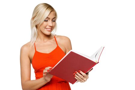 Smiling woman in bright red dress reading a book over white backgroundの写真素材