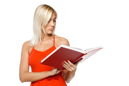 Woman in bright red dress reading a book over white backgroundの写真素材