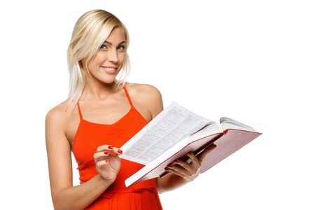 Smiling woman in bright red dress turning the pages of a book over white backgroundの写真素材