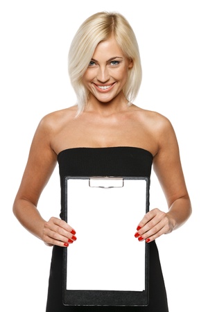 Smiling woman standing showing white paper clipboard, over white backgroundの写真素材