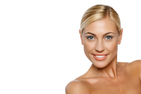 Closeup portrait of a beautiful blond female model on white backgroundの写真素材