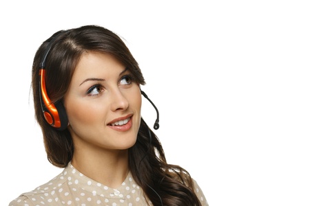 Smiling cheerful support phone operator woman in headset looking to the side at blank copy space, isolated on white backgroundの写真素材