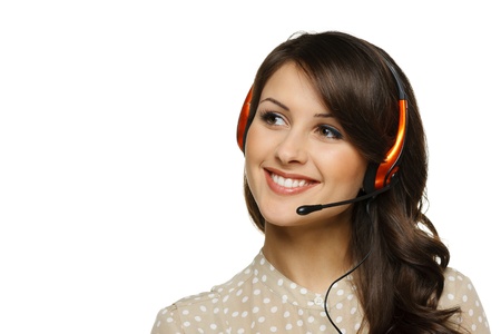 Smiling cheerful support phone operator woman in headset looking to the side at blank copy space, isolated on white backgroundの写真素材