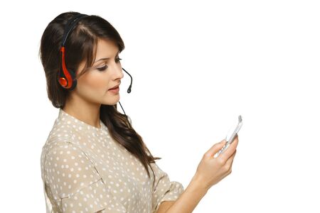 Smiling cheerful woman in headset with cellphone, isolated on white backgroundの写真素材
