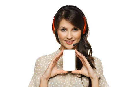 Smiling cheerful support phone operator woman in headset holding empty business card, isolated on white backgroundの写真素材