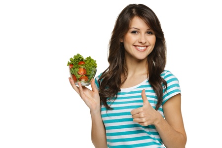 Woman holding healthy salad meal and showing thumb up sign, over whiteの写真素材