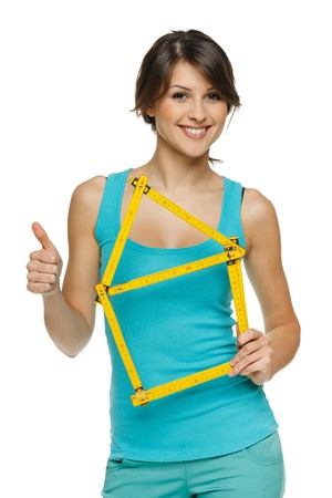Happy woman holding home frame and showing thumb up sign, over white backgroundの写真素材