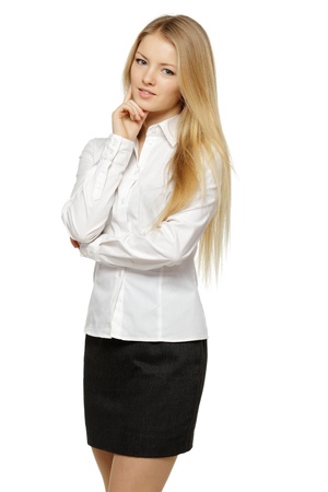 Portrait of young smiling female standing with folded hands over white backgroundの写真素材