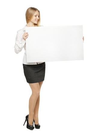 Full length of young female holding the blank board isolated on white backgroundの写真素材