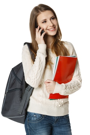 Happy woman university student with backpack and books talking on cell phone, looking out of frame, isolated on white backgroundの写真素材