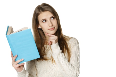 Closeup of thinking woman holding opened book and looking at the blank copy space, over white backgroundの写真素材
