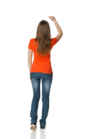 Back view of young casual female in full length writing on the blank copy space, isolated on whiteの写真素材