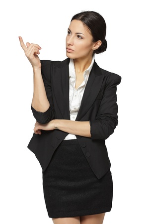 Young business woman pointing at white copy space, isolated on white backgroundの写真素材