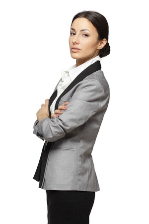 Portrait of business woman standing with folded hands, isolated on white backgroundの写真素材