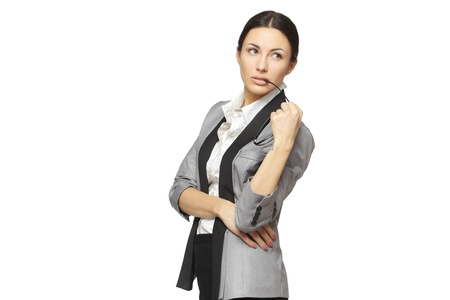 Young pensive female holding eyeglasses looking sideways, isolated on white backgroundの写真素材