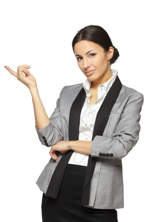 Young business woman pointing at white copy space, isolated on white backgroundの写真素材