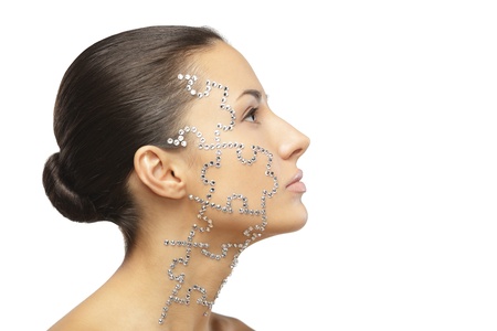 Side view portrait of female with beauty crystal puzzle on her face, isolated on white background, with copy-spceの写真素材
