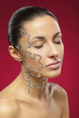 Portrait of female with beauty crystal puzzle on her faceの写真素材