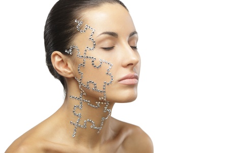 Female with beauty crystal puzzle on her face, isolated on white backgroundの写真素材