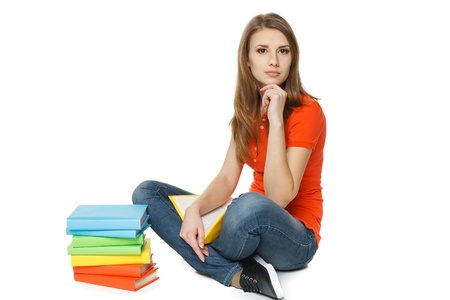 Calm woman sitting on the floor with stack of books, over white backgroundの写真素材