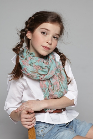 Portrait of little girl sitting on the chairの写真素材