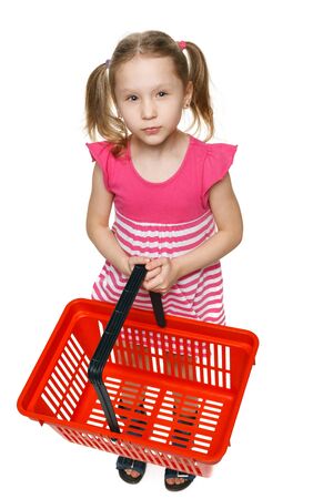 Little shopper  Little girl in full length holding empty shopping basket and thinking what gifts to buy, over white backgroundの写真素材
