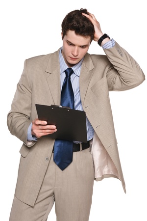 Young business man with clipboard holding his head in frustration, agains white backgroundの写真素材